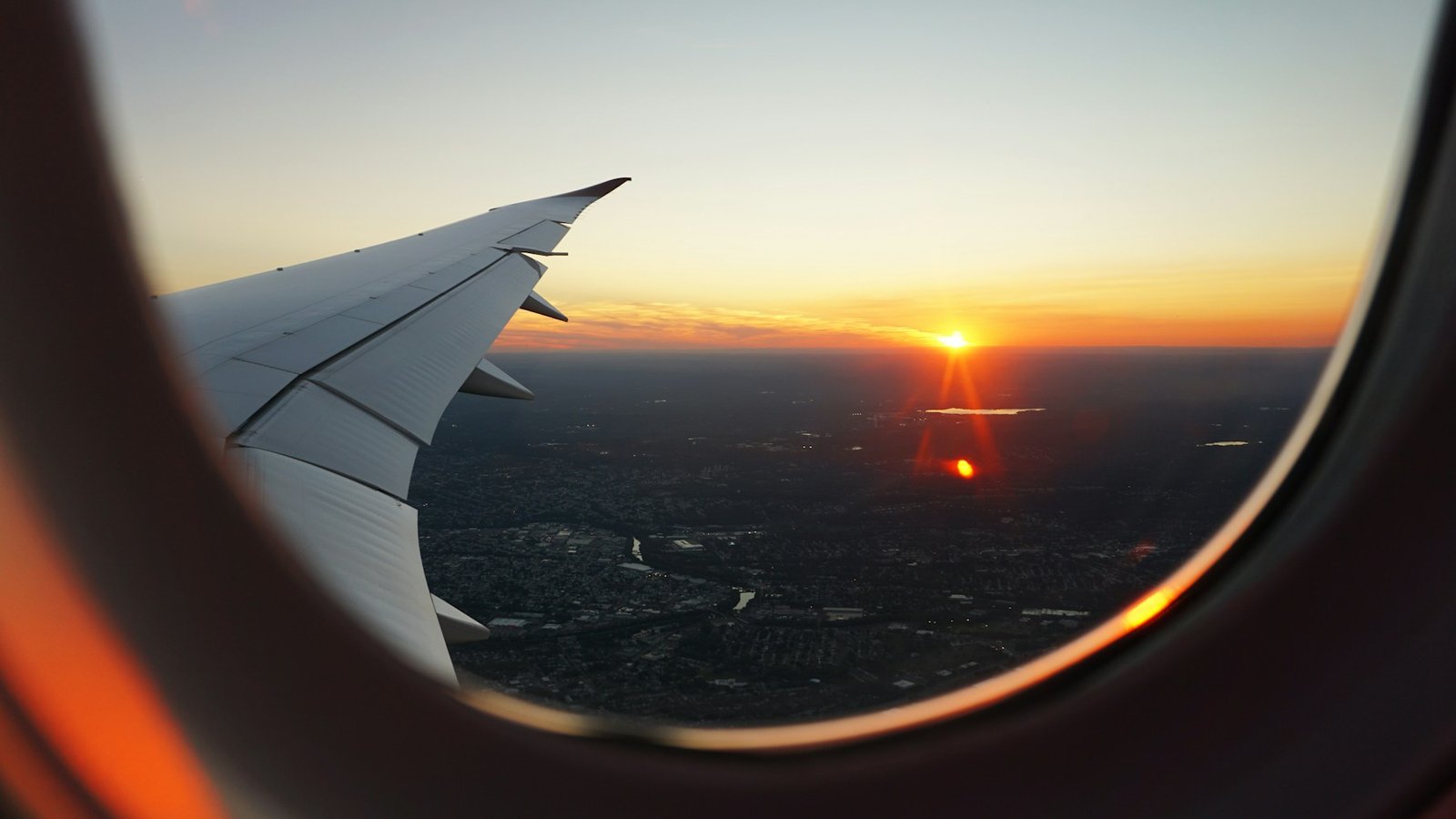 Vue depuis un hublot d’avion au coucher du soleil